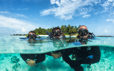 three divers at the blue sea