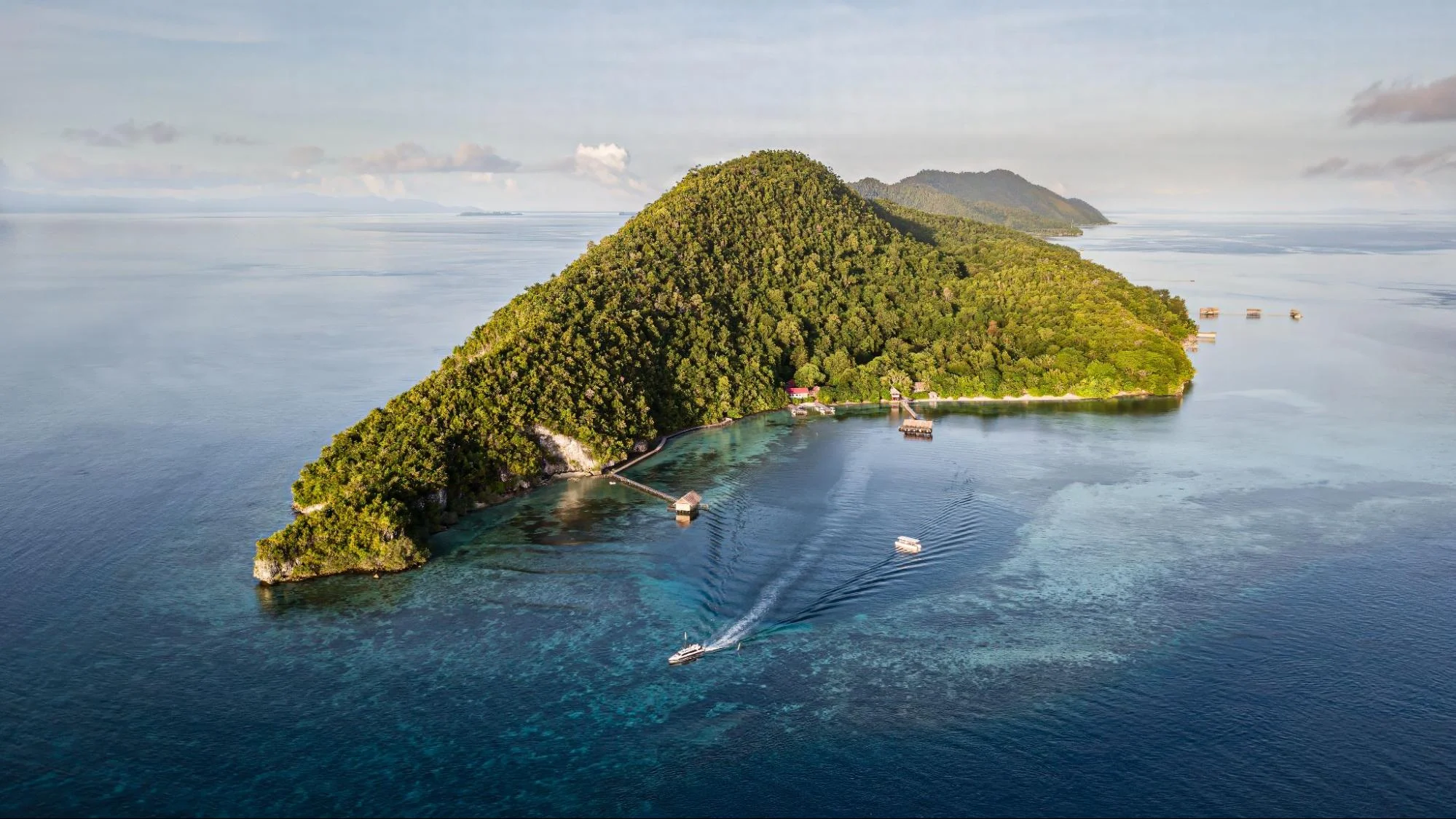 Aerial view of Papua Diving Resorts; Sorido Bay Resort and Kri Eco Resort located on Kri Island in Raja Ampat, Indonesia