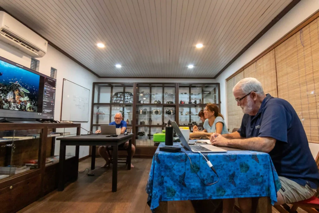 Don Silcock presenting slides to SEACAM workshop participants during a training session held at Papua Diving Resorts