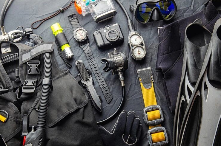 Flat lay of essential underwater photography and scuba diving gear for a Raja Ampat dive trip