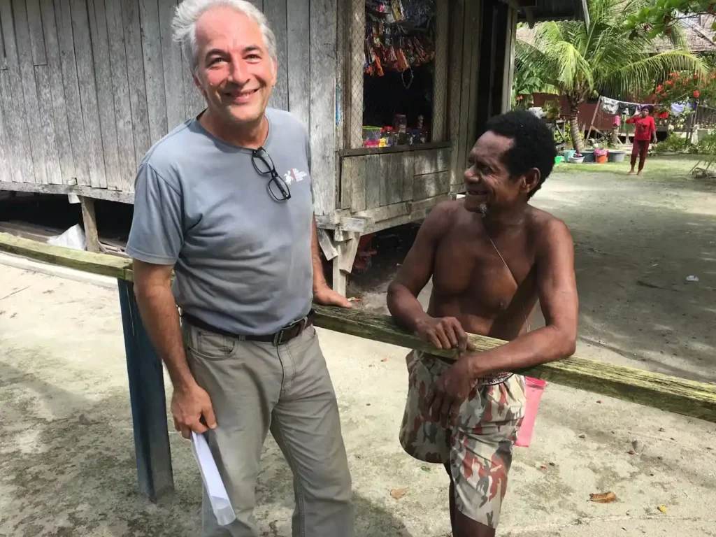 Max Ammer and a local Papuan share a warm, genuine moment