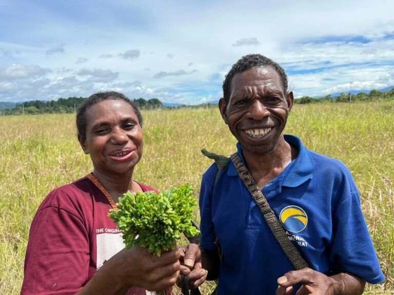 local papuan with vegetable in hand